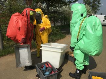 Einsatzkräfte in einem Chemieschutzanzug.